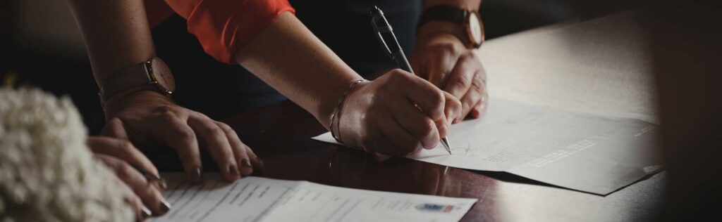 A couple going over and signing their will.