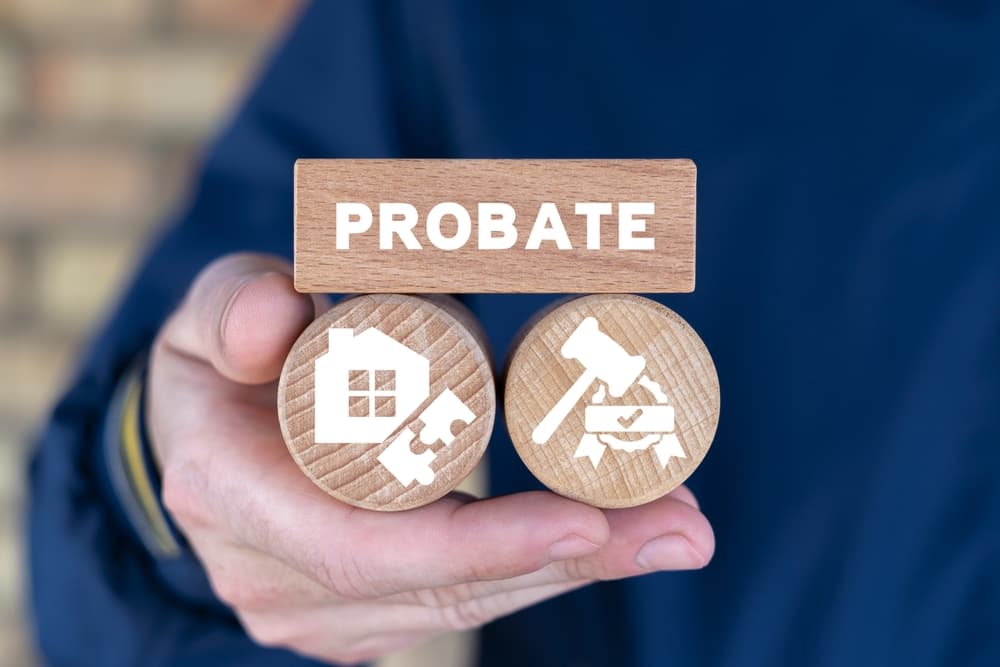Lawyer holding wooden blocks and sees text: PROBATE. Concept of Legal Legacy. Probate Wealth House Estate. Inheritance of property by court decision.