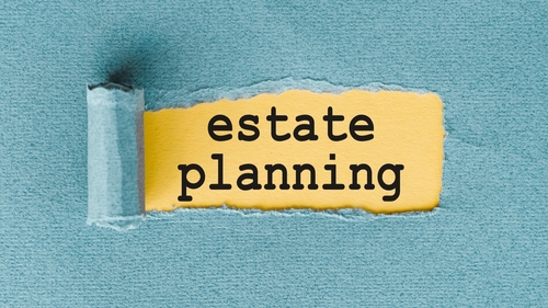 A torn blue paper background revealing the words “estate planning” printed in bold black text on a yellow strip.