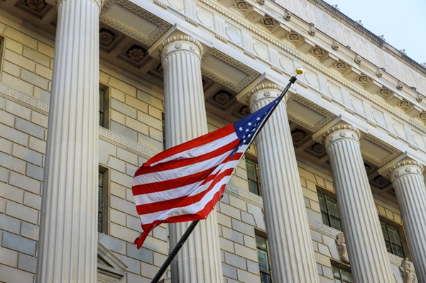 Courthouse building detail with waving American flag in USA
